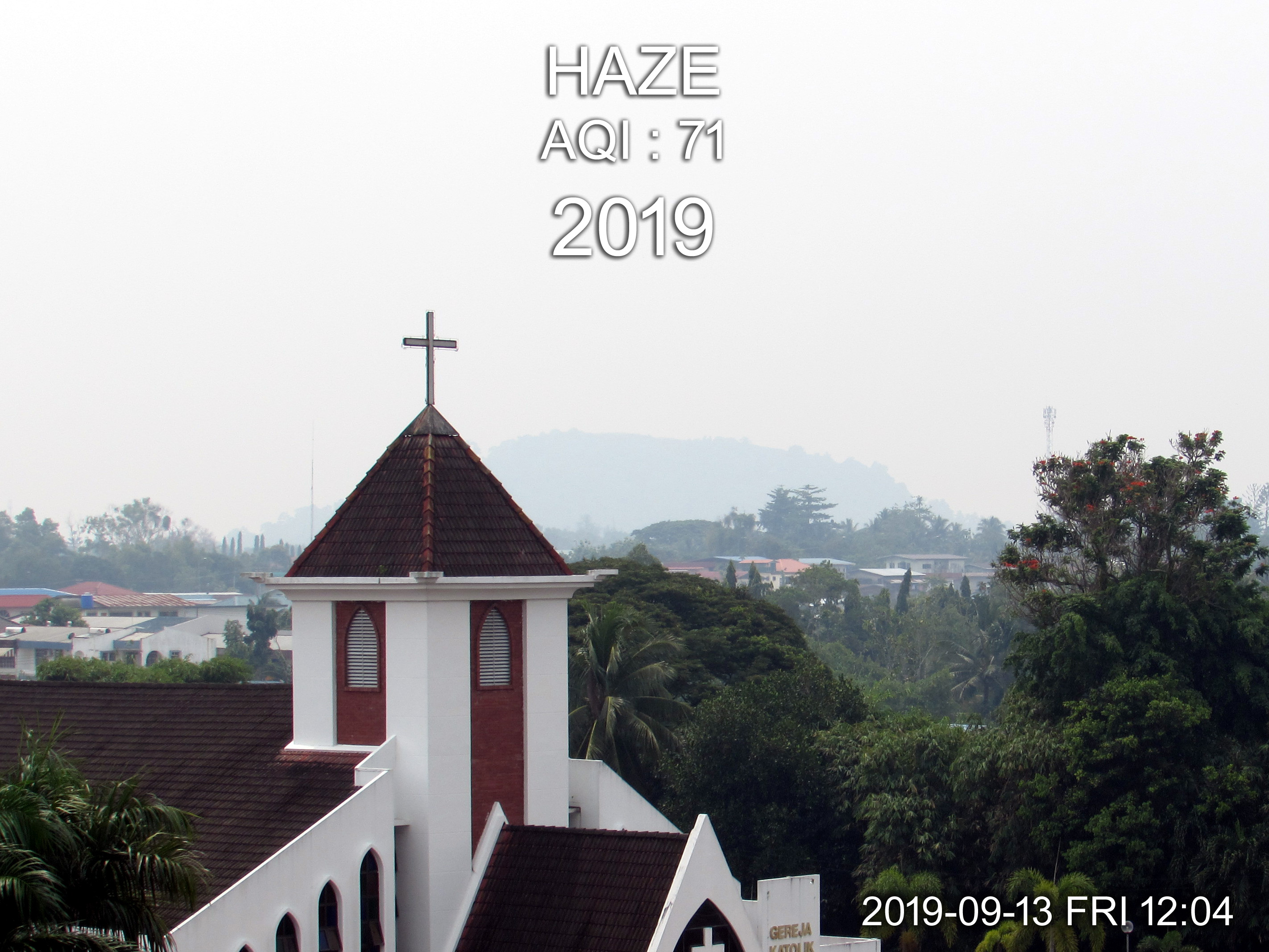 Haze in Tawau as view with background of Bukit Kukusan behind Holy Trinity Church 