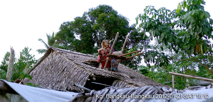 Two Bobohizan (high priestess or a spirit medium) conducting rites on a roof top of a sick man.