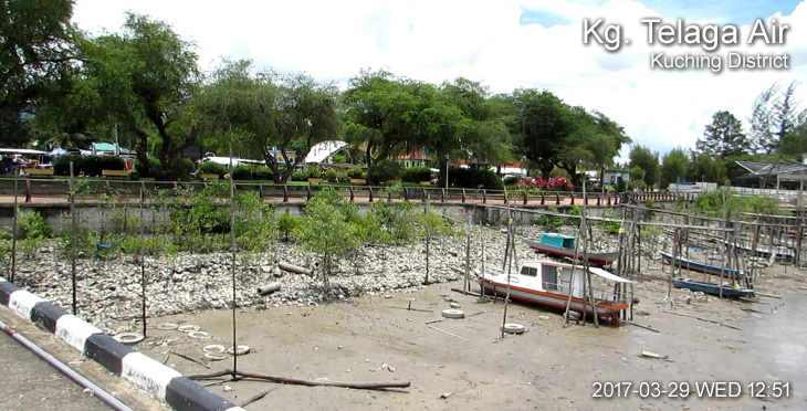 A view from a concrete jetty of roadside eatery and stalls of Kampung Telaga Air.