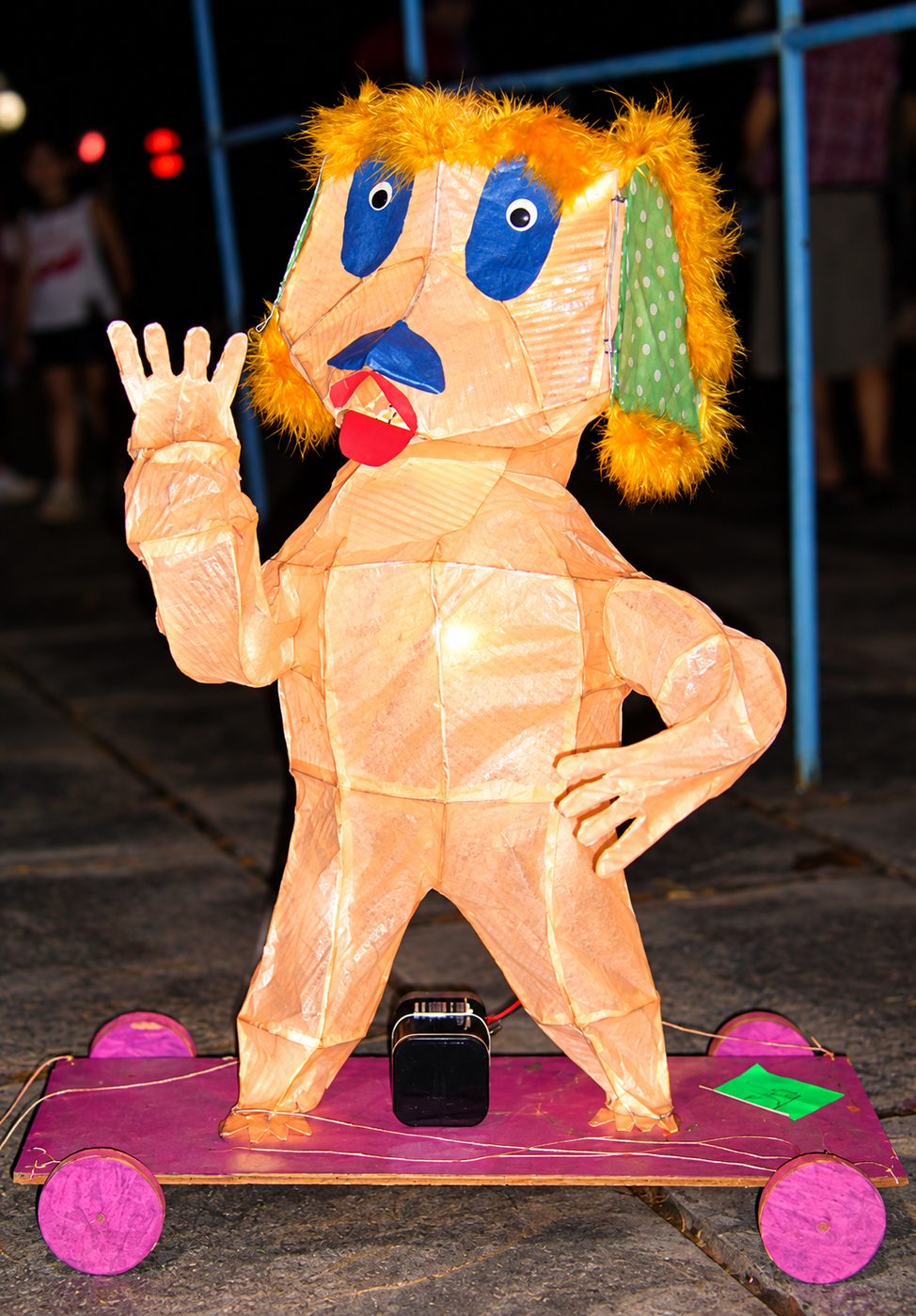 Waving figure lantern on wheels